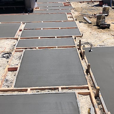 Freshly laid concrete pavers of various rectangles and squares creating a pathway