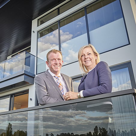 Craig Brown Photographer's image of two real estate agents standing on a balcony