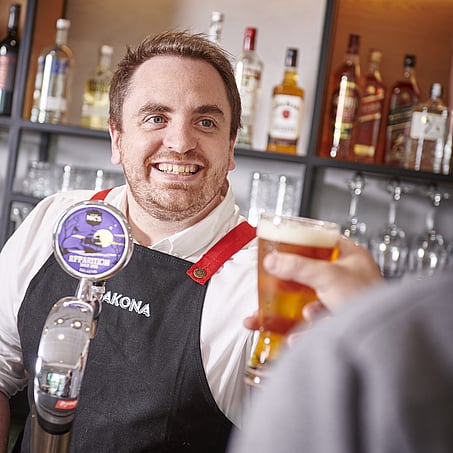 Craig Brown Photographer's image of a bar tending serving a beer