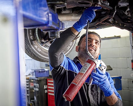 Craig Brown Photographer's image of a mechanic working under a car