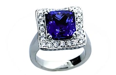 Cushion cut Tanzanite ring approximately 6.5ct with round brilliant diamonds set in Platinum