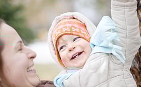 Child Carer with happy baby
