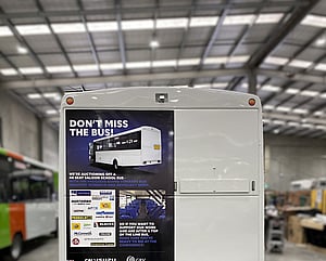 Advertisement vehicle graphics on back of bus