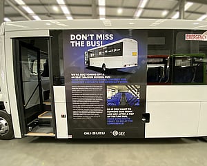 Advertisement vehicle graphics on side of bus