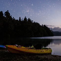 Kayaks on the shoreline under star lit skies allowing incredible stargazing on clear nights