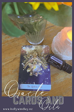 The Royal You Oracle Card, Patchouli Essential Oil, a candle and a vase of flowers