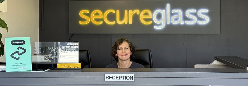 Photo of Secure Glass reception area with lady at the front desk.