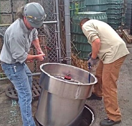 Two men installing a petro-barrier