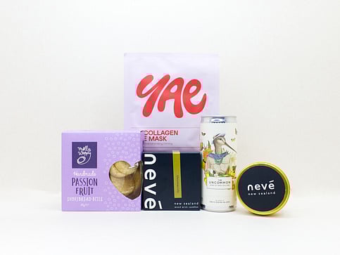 nz cookies, facemask, candle and a can of wine