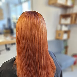 A long, straight copper hair colour by Hair by Shiyee.
