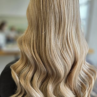 A beautiful wavy golden blonde colour by Hair by Shiyee.