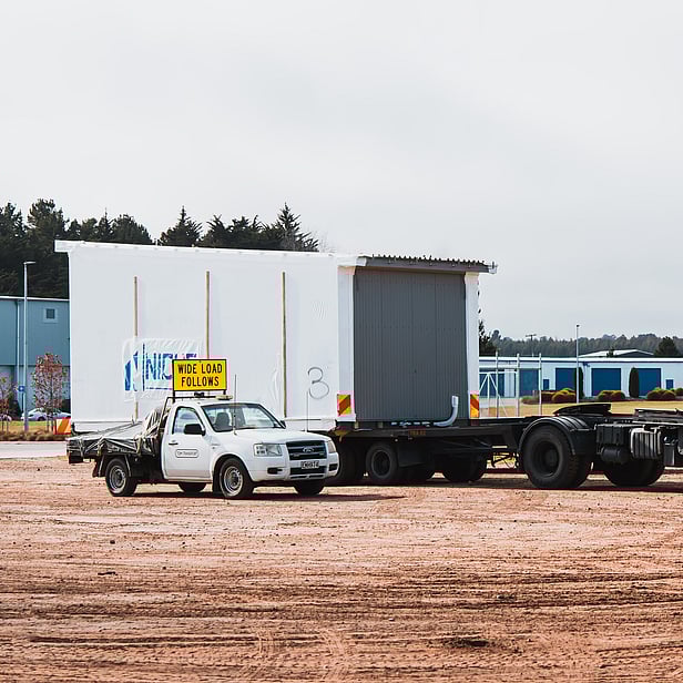 TDM Transport wide load piloting moving modular building in Hamilton New Zealand