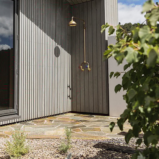 Outdoor shower are with natural custom paving by Ultrascape Landscaping