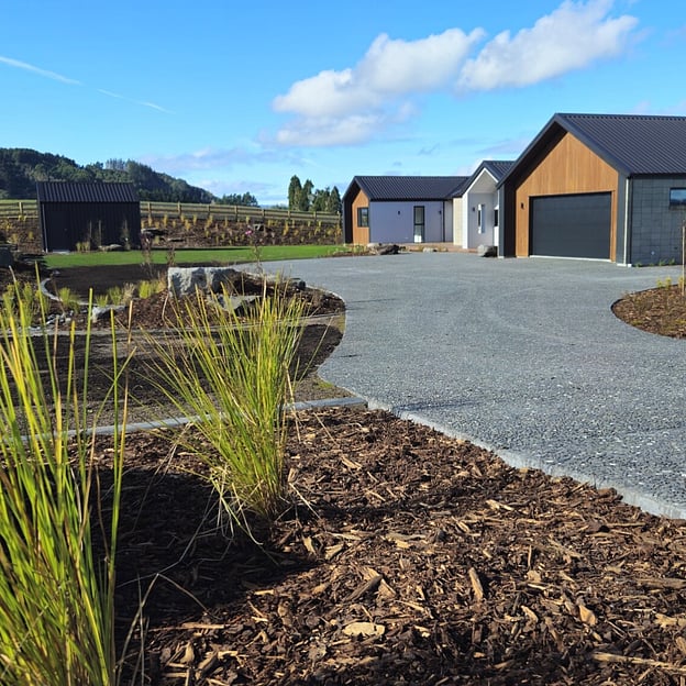Rotorua landscaped garden featuring a pool, garden bed designed with native plants and rolled grass