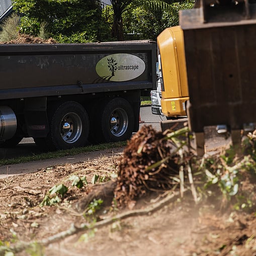Ultrascape team using a digger to clear land for site preparation