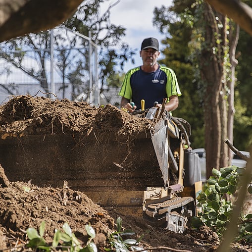 Ultrascape team removing site debris after clearing land for site prep
