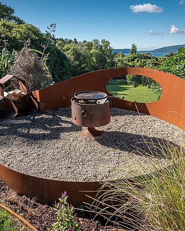 Custom landscape design with native planting and stone features and rolled lawn