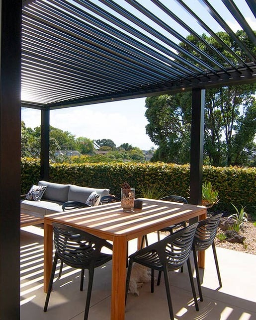 Outdoor patio with aluminium louvre roof system for sun control for a beautiful house in Rotorua