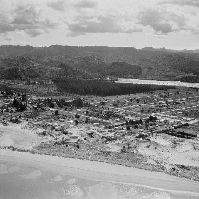 Old black and white aerial image of the Whangamata township in 1955 