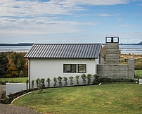 Pool house design with fair face concrete fireplace