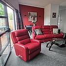 Living room of 14A Cologne Street with red leather sofa and lazy boy chairs