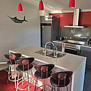 The grey and white kitchen and island bench at 14 Cologne Street