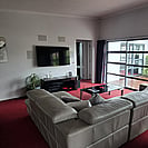 View of large TV from behind the sofa at 14 Cologne St