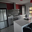 The grey and white kitchen and island bench at 14 Cologne Street