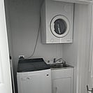 Full laundry facilities with washing machine, dryer and iron