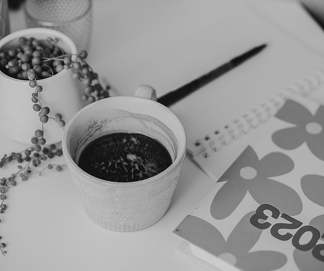 Image of coffee cup and diary. Image for blog post about how to come up with business name, plus tips and resources. Creative Box, New Zealand