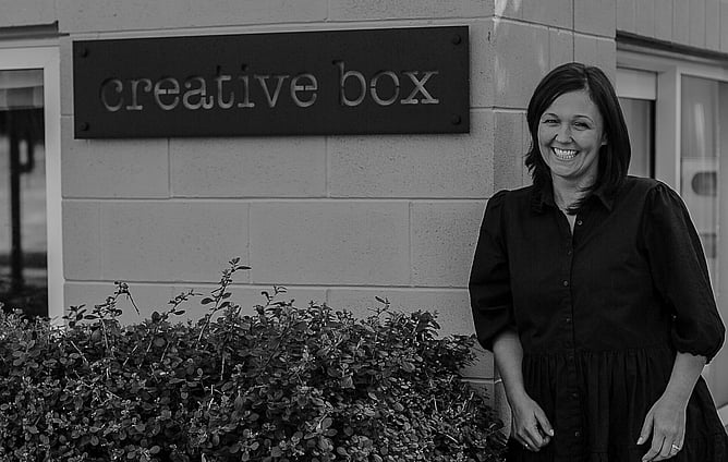 Image of designer, Kelly Boxell with her sign. Image for blog post "My favourite signage styles for 2023". New Zealand.