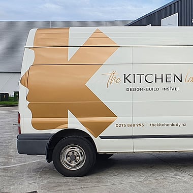 One-way vision signage on rear window of commercial van