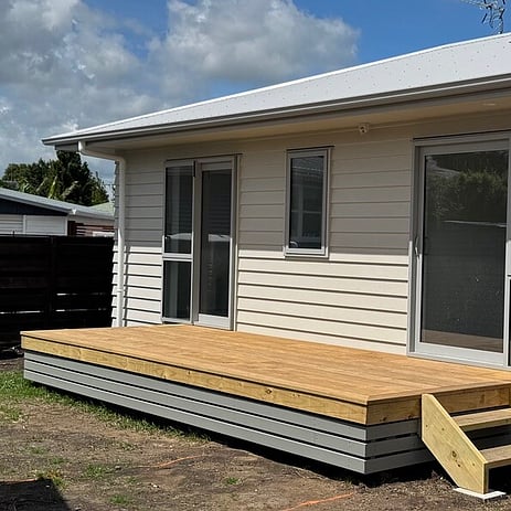Image of small beige building with decking on Lilac Street. Built by Ardent Building Developments, Hamilton. Waikato, New Zealand.