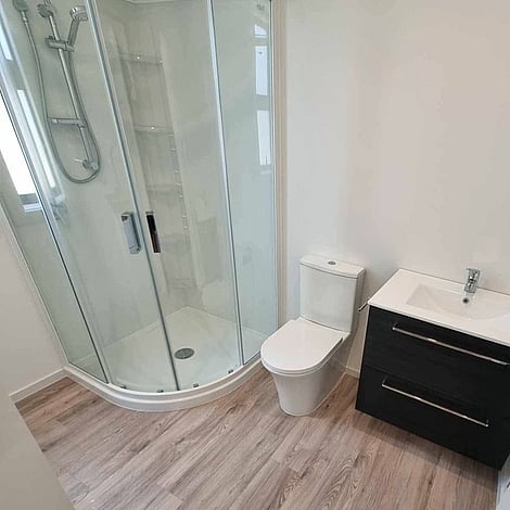 Image of fresh new neutral toned bathroom with dark cabinetry. Clarkin Road small building. Built by Ardent Building Developments, Hamilton. Waikato, New Zealand.