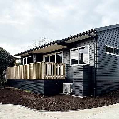 Image of a moody dark blue cladded small building with decking on Vercoe Road. Built by Ardent Building Developments, Hamilton. Waikato, New Zealand.