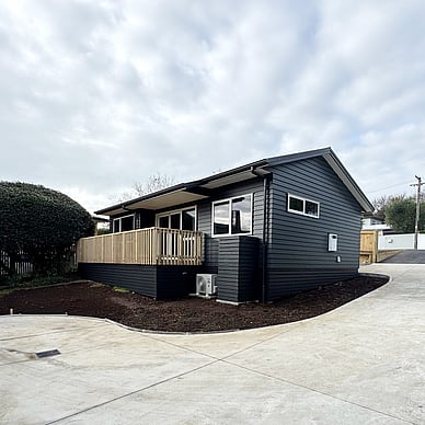 Image of a moody dark blue cladded small building with decking on Vercoe Road. Built by Ardent Building Developments, Hamilton. Waikato, New Zealand.