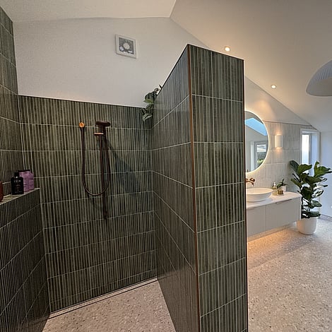 Image of a beautiful vertical finger tiled shower with copper fittings in this Bedford Road bathroom extension. Built by Ardent Building Developments, Hamilton. Waikato, New Zealand