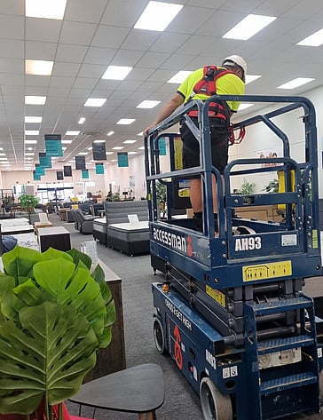 Commercial Electrician in Hamilton installing panel lights