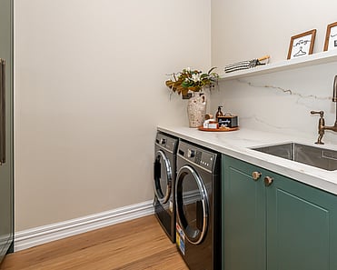 Image of newly renovated heritage laundry room in deep sage & white. Renovated by local Te Awamutu residential builders, Whitechurch Construction.