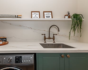 Image of newly renovated heritage laundry room in deep sage & white. Renovated by local Te Awamutu residential builders, Whitechurch Construction.
