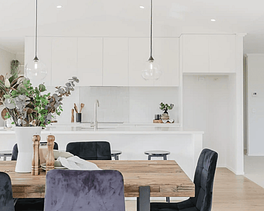 Image of light filled dining area and white washed modern kitchen in Collinson Street, Pirongia new home, by Waikato residential builders Whitechurch Construction Limited.
