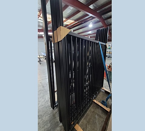 photo of pre-assembled panels, on a rack, ready for delivery to Auckland
