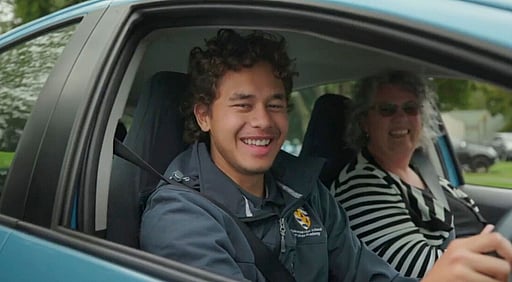 Two people smiling in a car