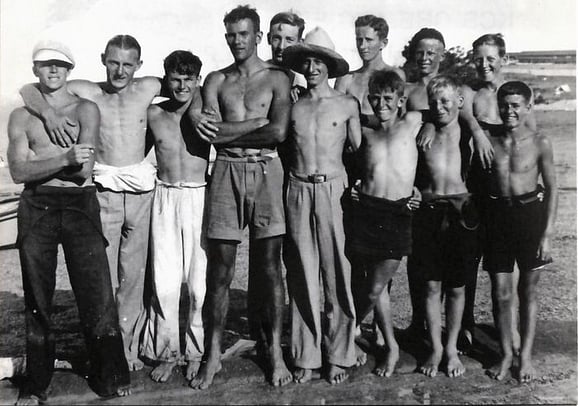 Twelve foundation members of the Wakatere Canoe Club after a sailing race in 1928. Left to right - Ron Hunt, Bert Williamson, Sid Ivill, John Brooke, Warren Bond, Sid Lydford, Owen Probert, Bon Grut, Jack Hunt, George Kemp, Roy Lockwood and John Gordon.