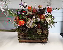 Frsh and dried flower arrangement in rustic crate