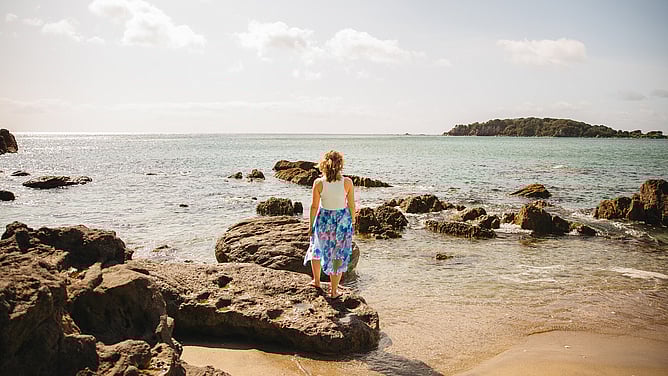 Amy Brailey, strategic brand designer for the wedding industry, looking out at sea