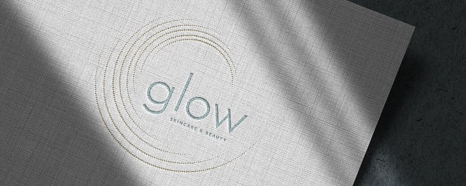 Glow Skincare & Beauty Logo on textured paper representing wedding business branding