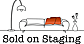 Sold on Staging logo featuring a black line drawing of a sofa with an orange throw, a floor lamp, and a vase with flowers, with the company name below