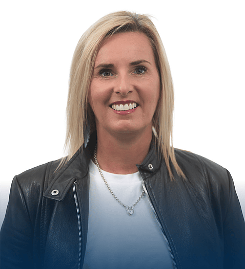 A professional headshot of Adele, smiling and wearing a black leather jacket, with a white background