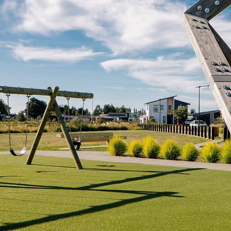 standing in park, on left is the a swing
